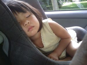 child sleeping in car